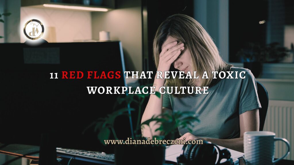 A tired woman sitting at her desk with her head in her hand, symbolizing the stress and burnout caused by a toxic workplace culture.