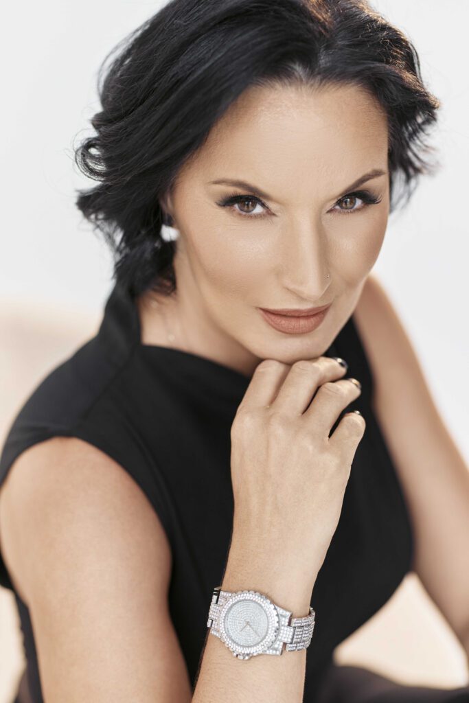 Diana Debreczeni professional portrait in black outfit, elegant pose and confident expression